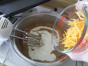 Mixing the other ingredients into the potato soup, yum!